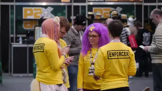 Enforcers at PAX Australia in 2013, with PAX signage behind them