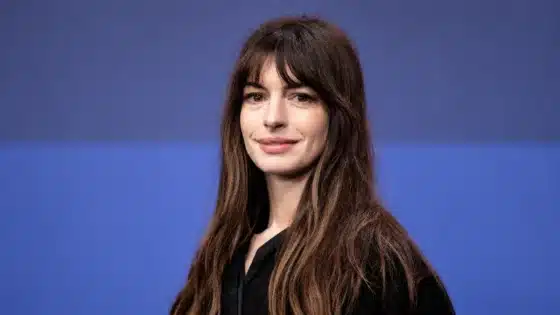 Anne Hathaway photographed against a blue backdrop at the 2023 Berlin Film Festival.